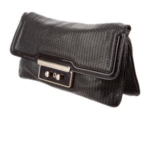 Stella McCartney black faux leather and gold clutch